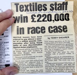 A coloured photograph of a newspaper article from T&A from 29th May 1993 titled 'Textiles Staff Win £220,000 in race case'. Photograph: Val Rowlands