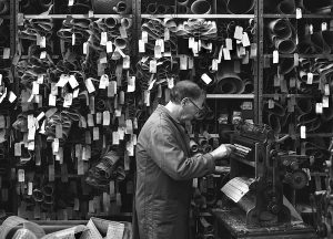 Black and white photograph of a man making pattern cards at Drummonds Mill. Photograph: Tim Smith