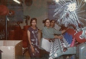 A coloured photograph of three British Asian women working in the Winding department of Benson Turners. Photograph: Sabi Chahal